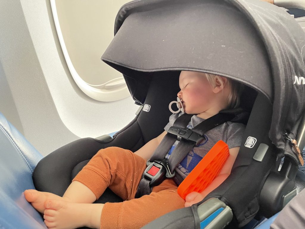 Toddler sleeping on airplane while traveling to hawaii 
