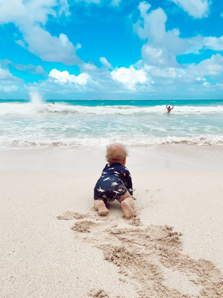 Toddler crawling at the beach