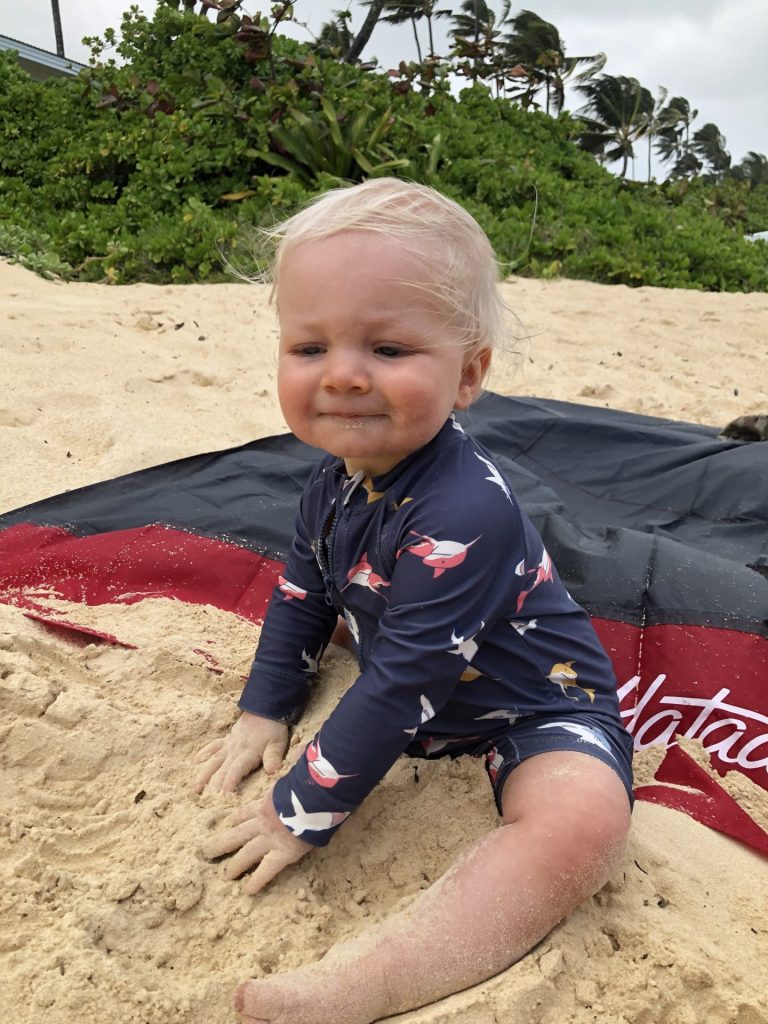 Toddler at the beach playing in the sand