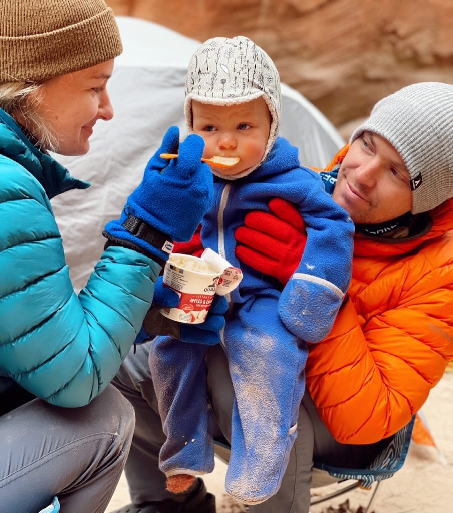 Hailey feeding her toddler oatmeal on their backpacking trip