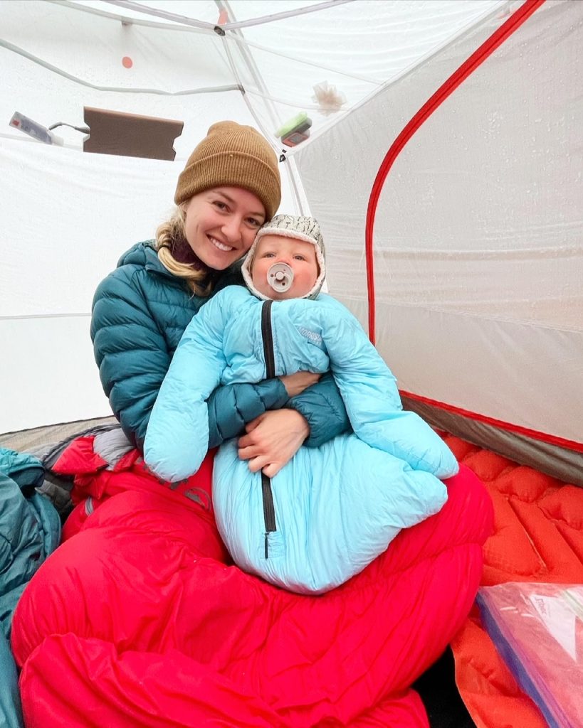 hailey and her toddler snuggling in the tent in the morning