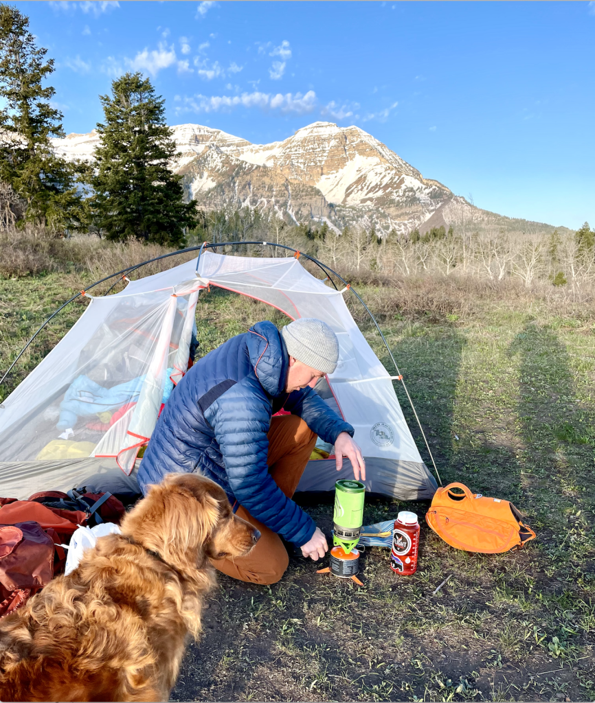 Dad boiling water while backpacking