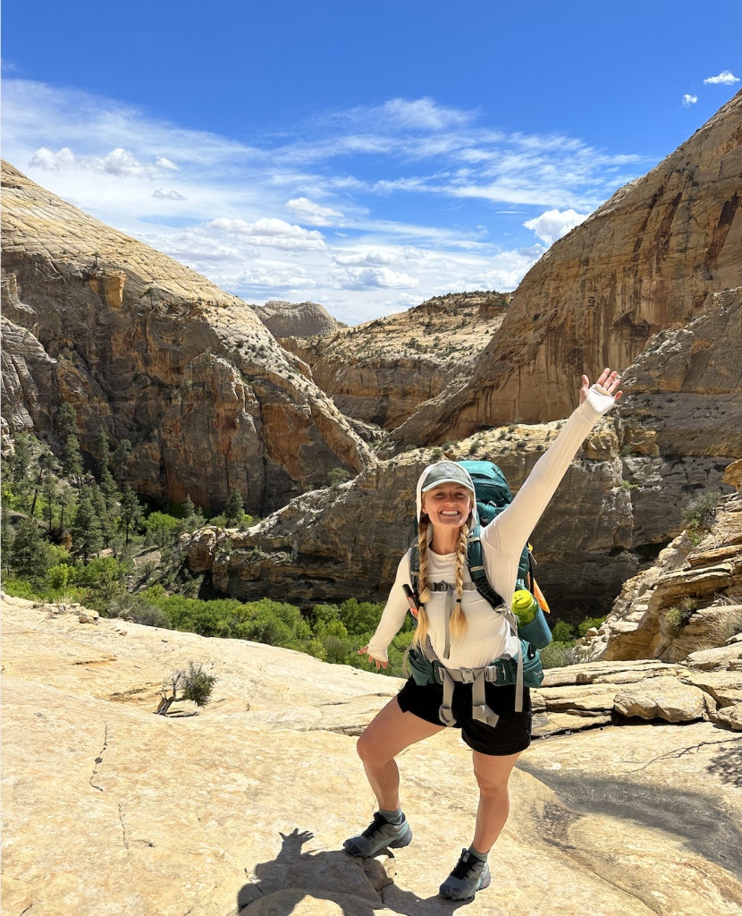 Hailey Hiking in the summer in the Utah desert wearing summer hiking clothing
